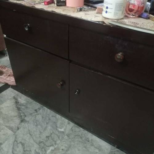 A low profile bed with mattress and side tables and dressing table 