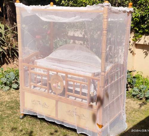 Wooden bed with baby cot swing