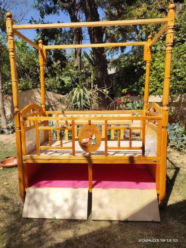 Wooden bed with baby cot swing