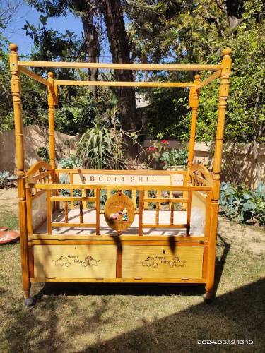 Wooden bed with baby cot swing
