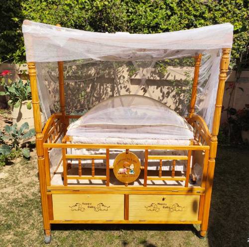 Wooden bed with baby cot swing