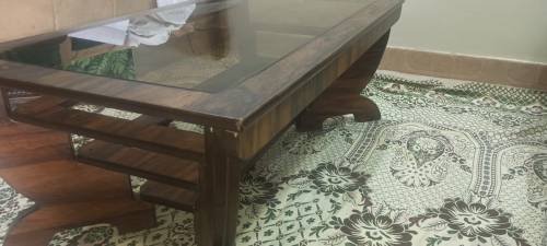 rectangular wooden table with glass in middle 