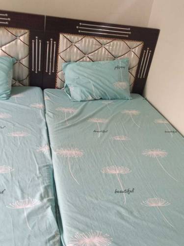 pair of single beds with mattress and side tables 