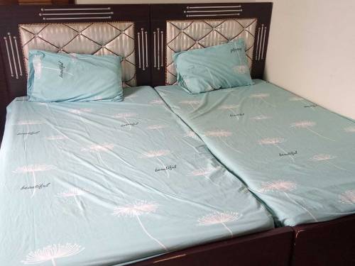 pair of single beds with mattress and side tables 