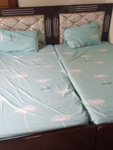 pair of single beds with mattress and side tables 