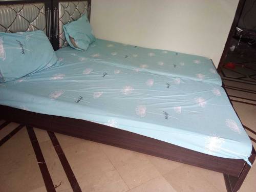 pair of single beds with mattress and side tables 