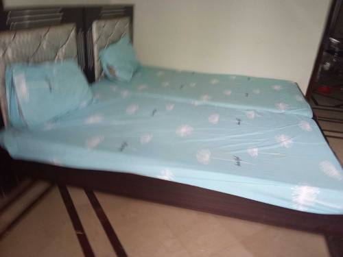 pair of single beds with mattress and side tables 